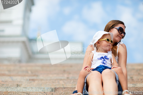 Image of Mother and daughter outdoors in city