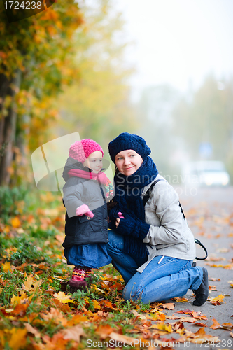 Image of Mother and daughter outdoors on foggy day