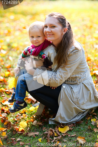 Image of Mother and daughter outdoors at autumn day