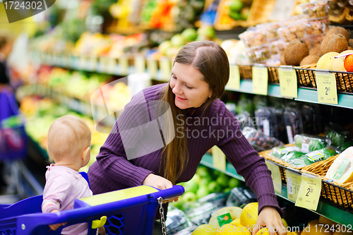 Image of Mother and baby daughter in supermarket