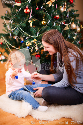 Image of Mother and daughter near Christmas tree