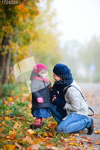 Image of Mother and daughter outdoors on foggy day