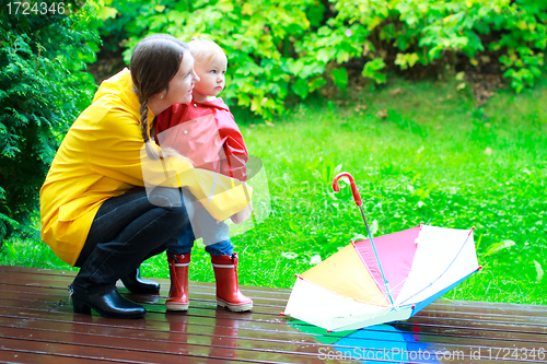 Image of Mother and daughter outdoors at rainy day
