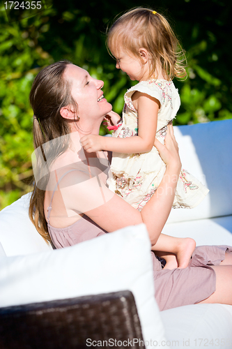 Image of Happy mother and daughter outdoors