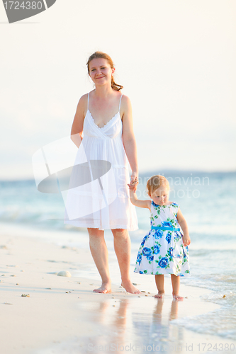 Image of Mother and daughter on tropical beach at sunset