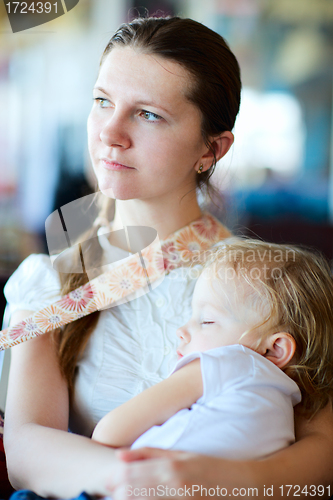 Image of Mother holding sleeping daughter