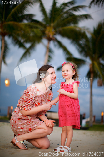 Image of Mother and daughter enjoying sunset