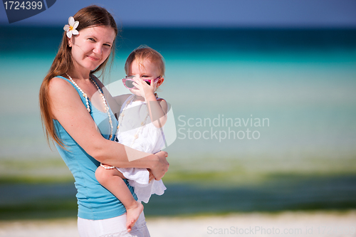 Image of Young mother holding baby daughter