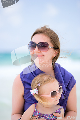 Image of Happy mother and daughter at beach