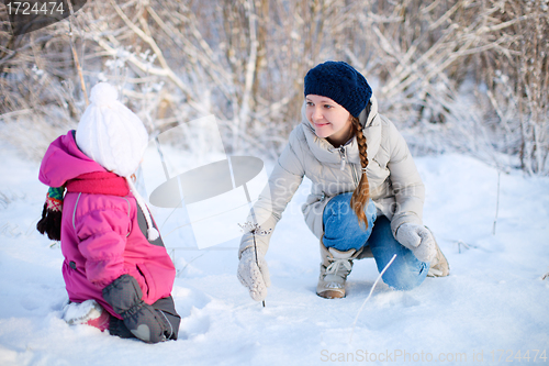 Image of Mother and daughter outdoors at winter
