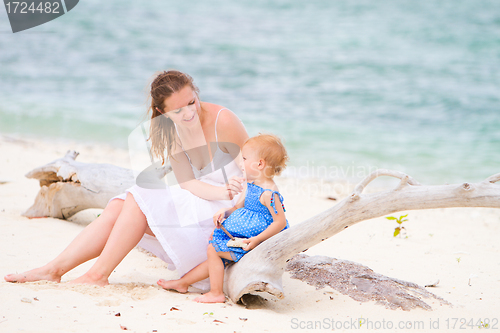 Image of Mother and daughter on tropical white sand beach