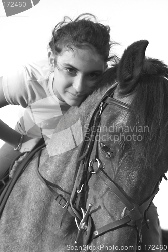 Image of girl riding a horse in black