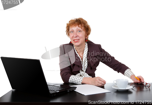 Image of Middle-aged woman at the table, a laptop