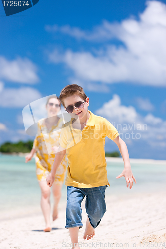 Image of Mother and son running at beach