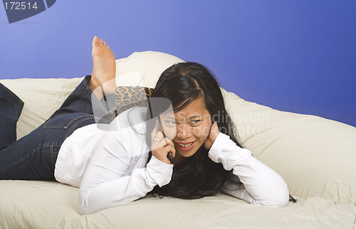 Image of laying down on couch with phone