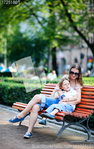 Image of Mother and son on bench in park