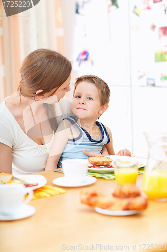 Image of Mother and son in kitchen at morning