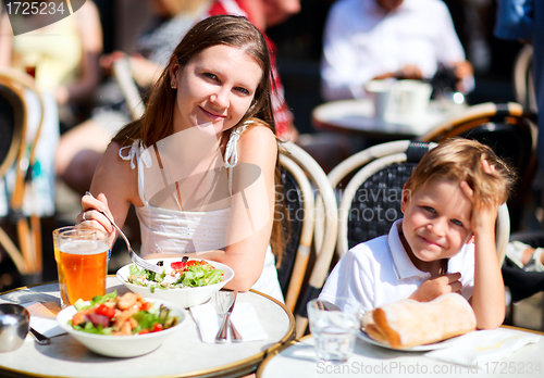 Image of Mother and son having lunch in sidewalk restaurant