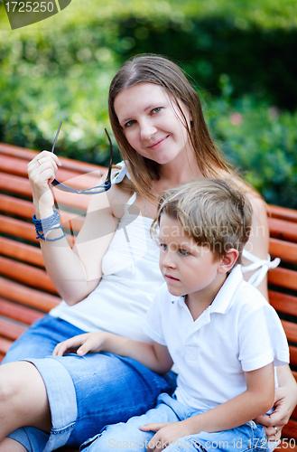 Image of Closeup of mother and son sitting outdoors