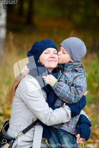 Image of Boy kissing his mother outdoor