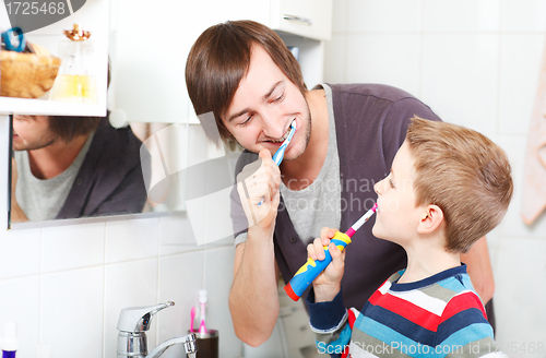 Image of Father and son brushing teeth