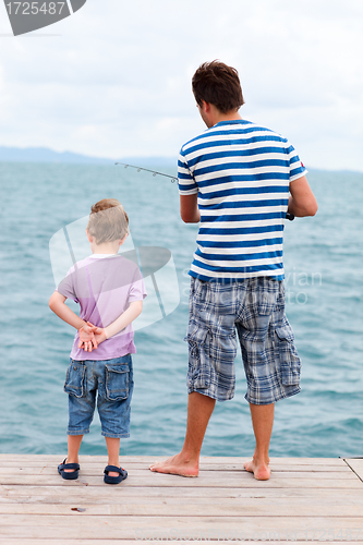 Image of Father and son fishing from pier