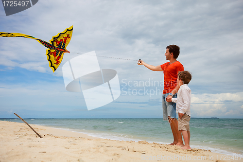 Image of Dad and son flying kite