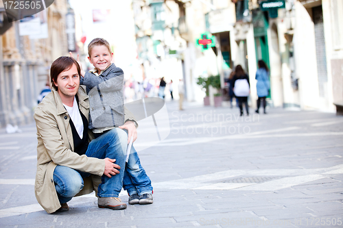 Image of Father and son outdoors in city