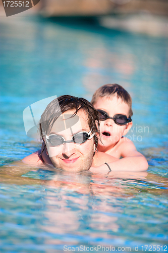 Image of Father and son in swimming pool