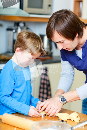 Image of Father and son baking together