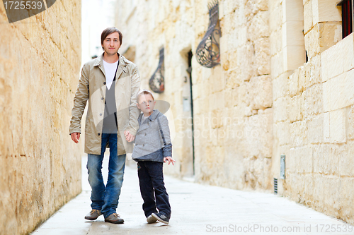 Image of Father and son outdoors in city