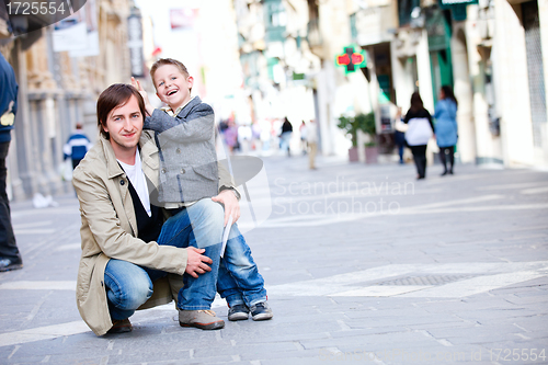Image of Father and son outdoors in city