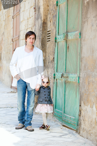 Image of Father and daughter outdoors in city