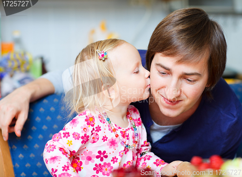 Image of Adorable little girl kissing her father