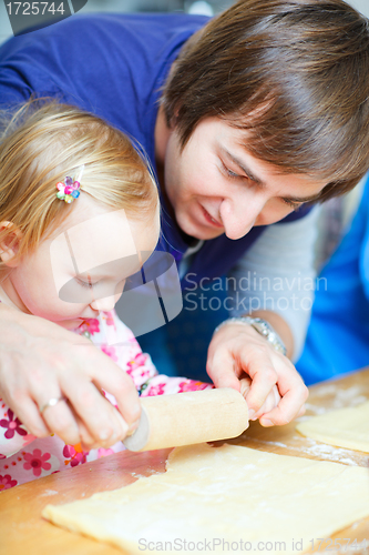 Image of Father baking together with his daughter