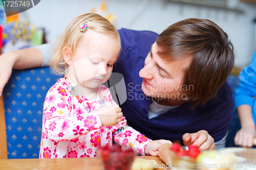 Image of Father and daughter baking