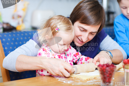Image of Father and daughter baking together