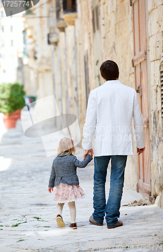 Image of Father and daughter outdoors in city