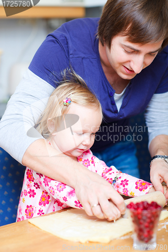 Image of Father and daughter baking together