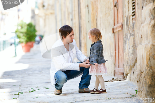 Image of Father and daughter outdoors in city