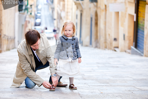 Image of Father and daughter outdoors in city