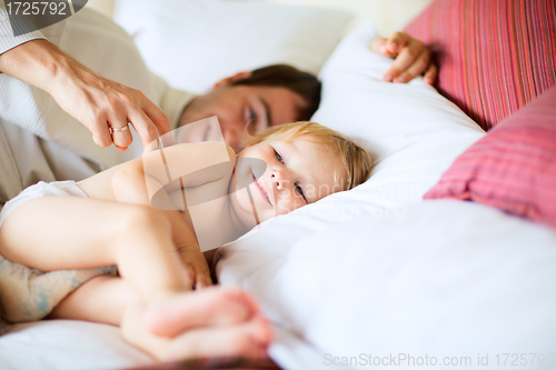 Image of Father and daughter in bedroom