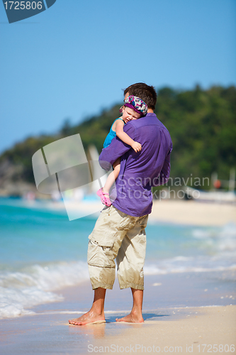 Image of Father and his daughter standing near oceanfront