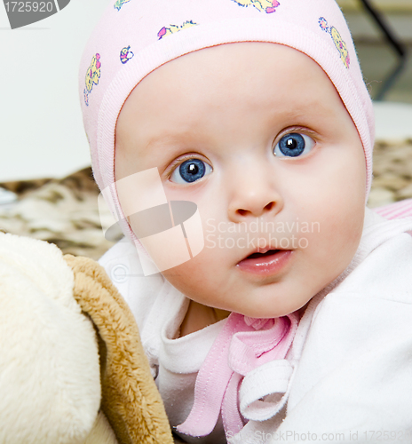 Image of baby with a soft toy