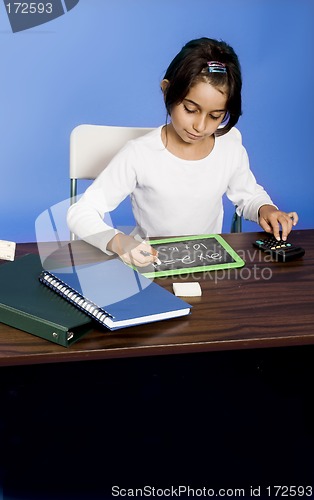 Image of little girl writing on board