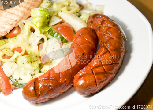 Image of debrecziner Hungarian sausage with salad