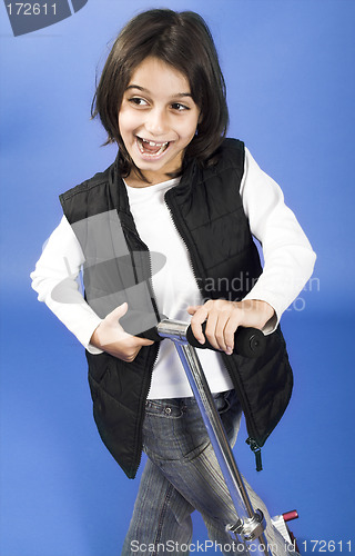 Image of little girl riding scooter
