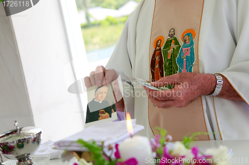 Image of Candle burning inside a church.