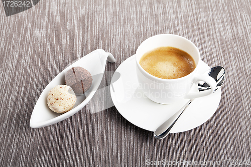 Image of cup of coffee with mixed pralines 