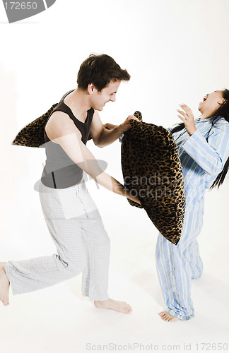 Image of couple fighting with pillows